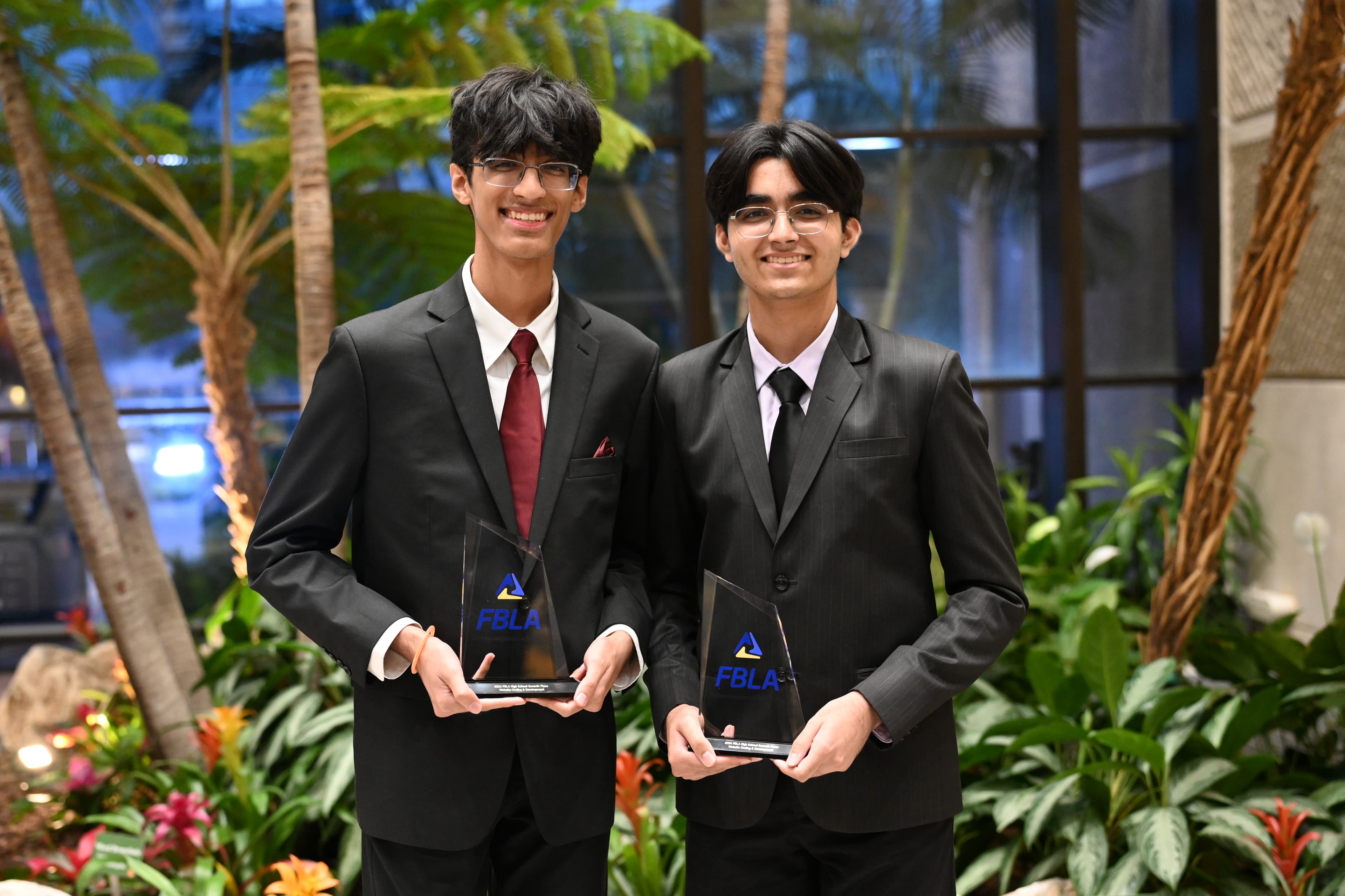 the team behind awmna holding FBLA NLC webdev 7th place trophies